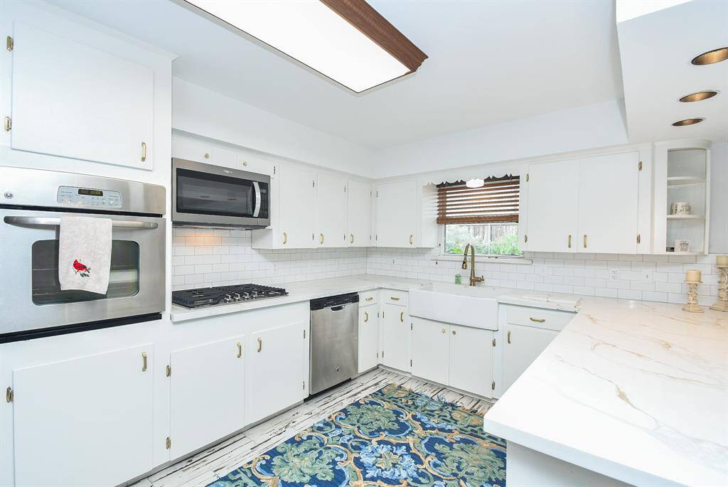 Wow! One can easily appreciate the beautiful upgrades to the incredible amount of cabinetry/storage in this easy-to-navigate kitchen --- and there's just something warming about a primarily white kitchen (or bath, for that matter) that seems to appeal to just about everyone!