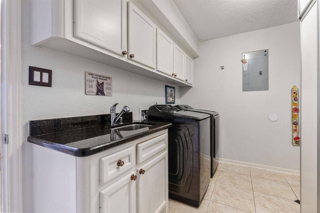 The huge first floor laundry room complete with a sink and a second built-in refrigerator