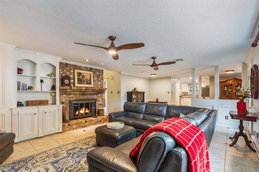 Huge living room with brick fireplace, built ins and plenty of space to entertain