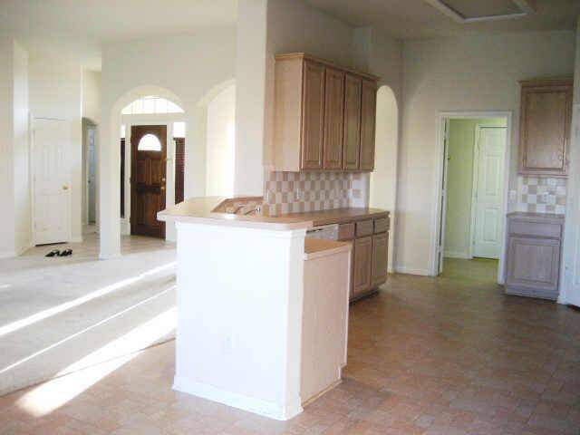 kitchen and breakfast area with nutural colors! cover patio by back door (for BBQ?)