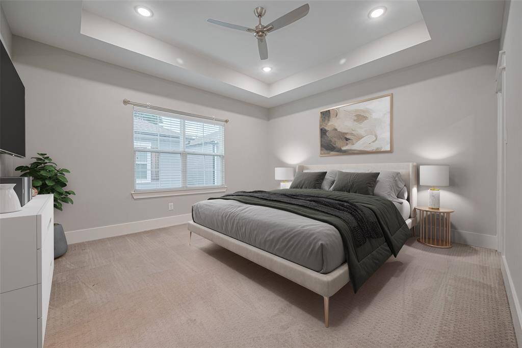 Primary bedroom suite with tray ceiling,2 walk-in closets and spa-like bathroom. (Virtually Staged)