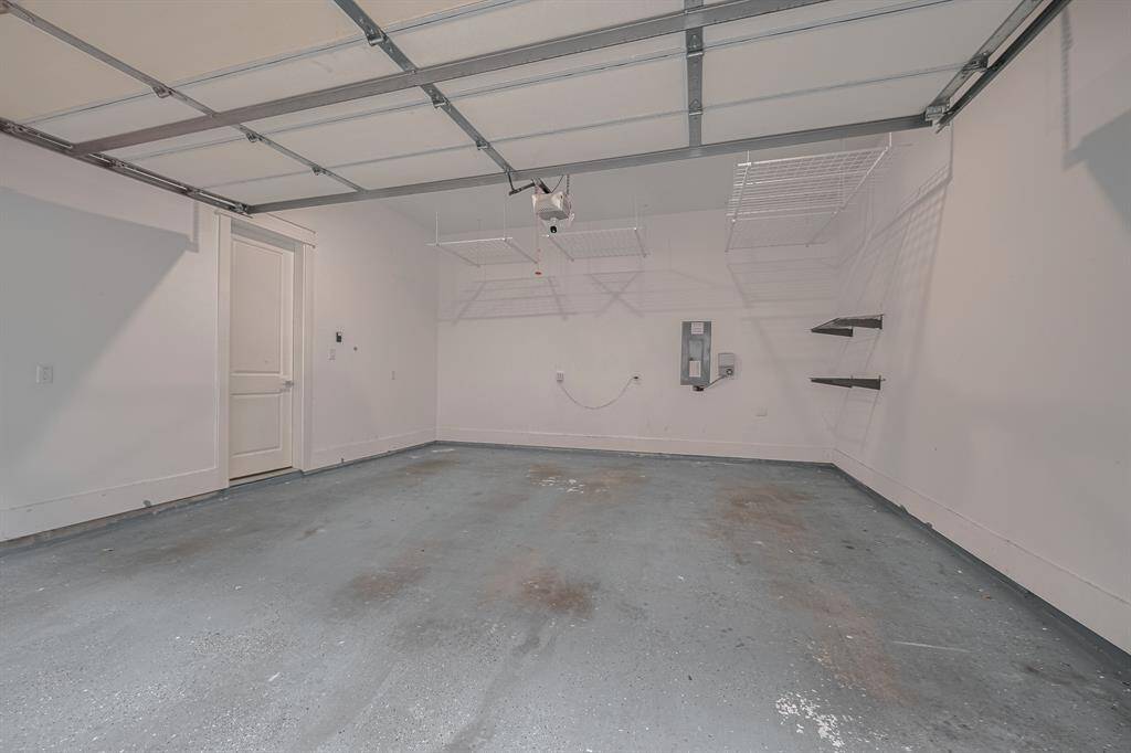 2 car garage with hanging storage and epoxy flooring. There is also an electric hookup to connect a generator that will power the house minus HVAC (per landlord).