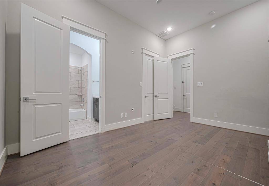 Downstairs bedroom with en suite bath, huge closet/storage walk-in and access to the side yard.
