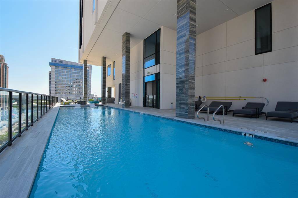A closer look at the rooftop pool, where you can unwind and take in the views. To the right, a cozy seating area provides the perfect spot to relax and enjoy the surroundings in comfort.