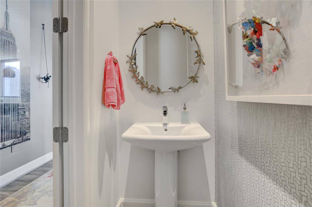 The conveniently located half bath, just off the entryway, offers easy access for guests.