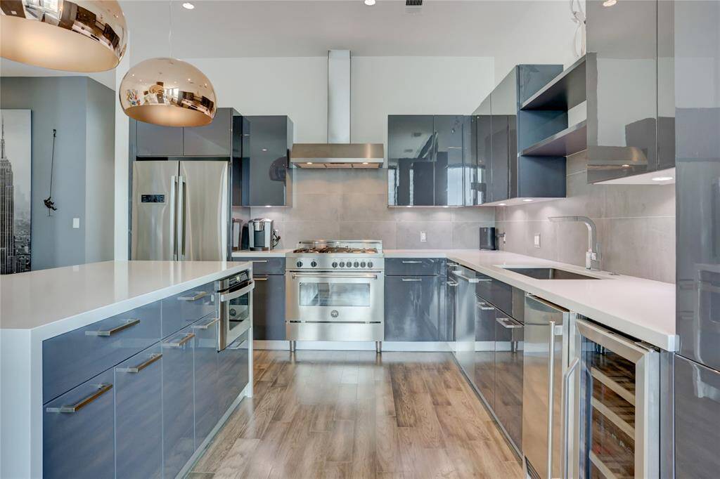 This kitchen checks all the boxes with sleek, soft-close cabinets, a gas range for serious cooking, a separate ice maker, and a built-in wine cooler; everything you need to cook, chill, and entertain in style.