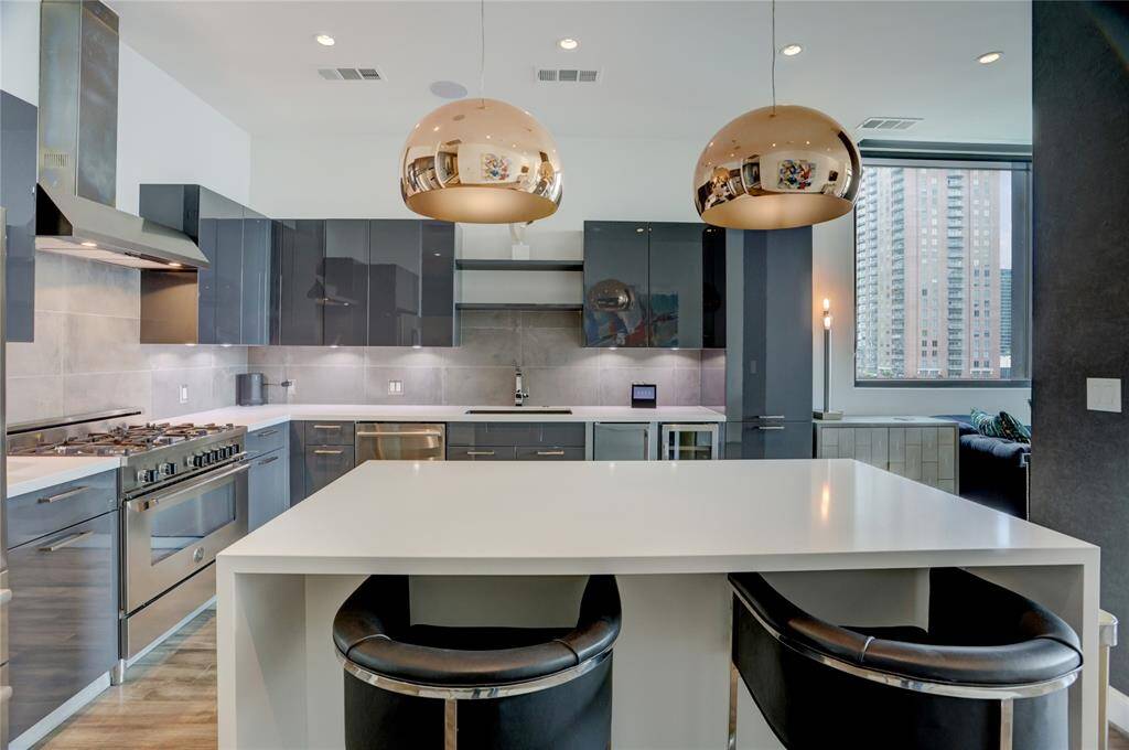 A view of the oversized island which is perfect for casual dining, morning coffee, or gathering with friends. This kitchen is a highlight in this unit.