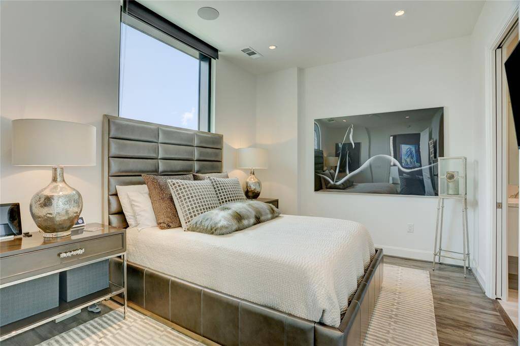 Step into the spacious primary bedroom, offering plenty of room to unwind. A large window fills the space with natural light, creating a bright and inviting atmosphere, while still providing a cozy retreat at the end of the day.