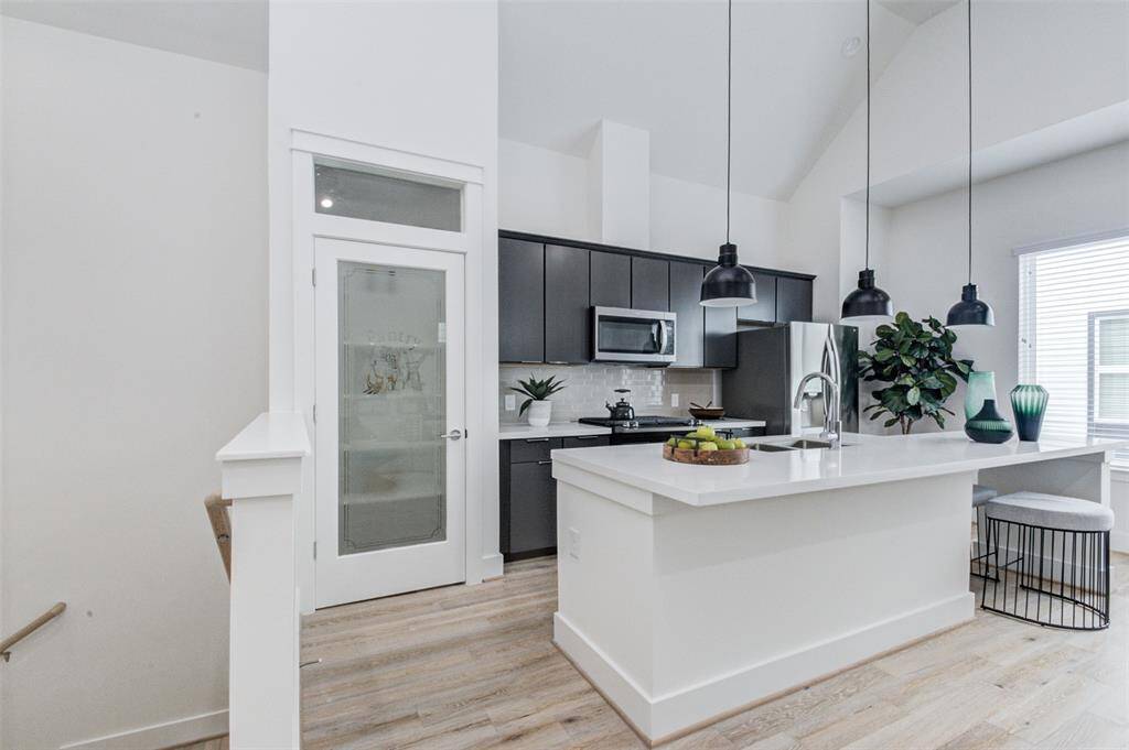The kitchen area with modern cabinetry, appliances and island. The pantry besides the kitchen for easy access. The pantry dor is different in the rental property