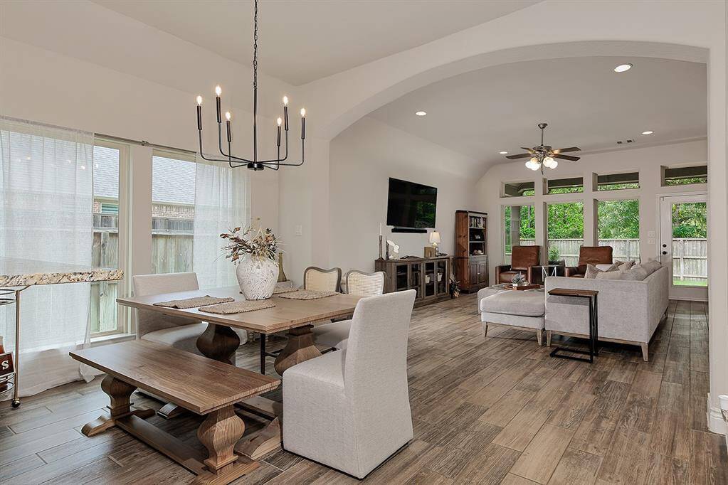 Dining room offers stylish chandelier, natural light and an easy flow for gatherings or quiet meals