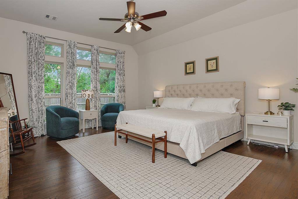 Rest comfortably and awaken to refreshing wooded views from the primary bedroom