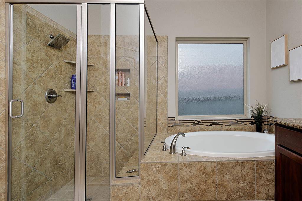 Natural light streams into the primary bathroom