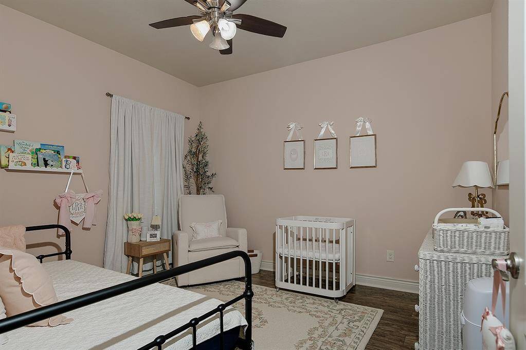 Secondary bedrooms have wood look tile floors and celing fans for comfortable sleeping