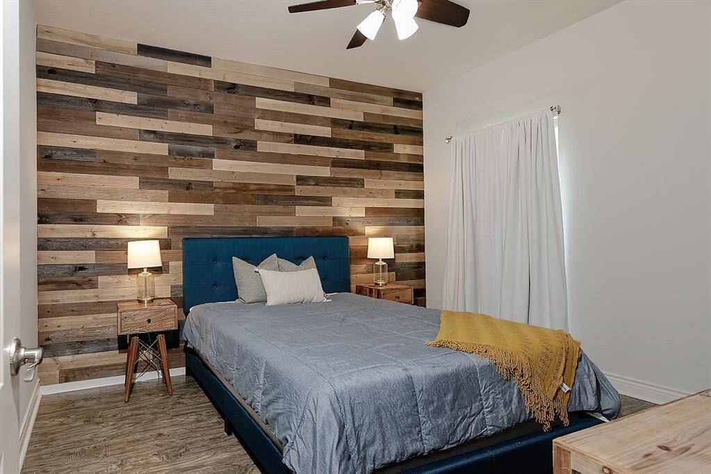 This secondary bedroom has a feature wall to complement your style