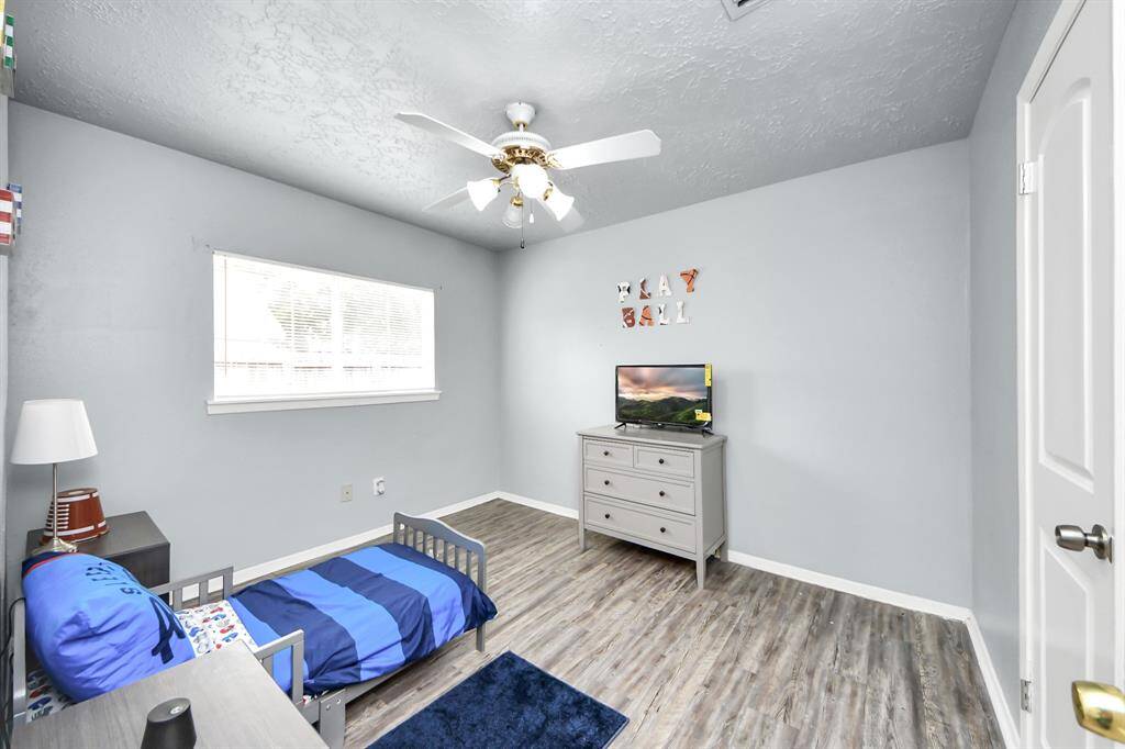 Bright and open kitchen with granite countertops and a central island. Large windows provide ample natural light, enhancing the airy feel. Adjacent to a cozy dining area and living space, perfect for entertaining.