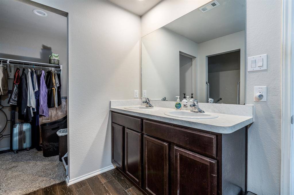 Double sinks and a large closet of the primary bath.