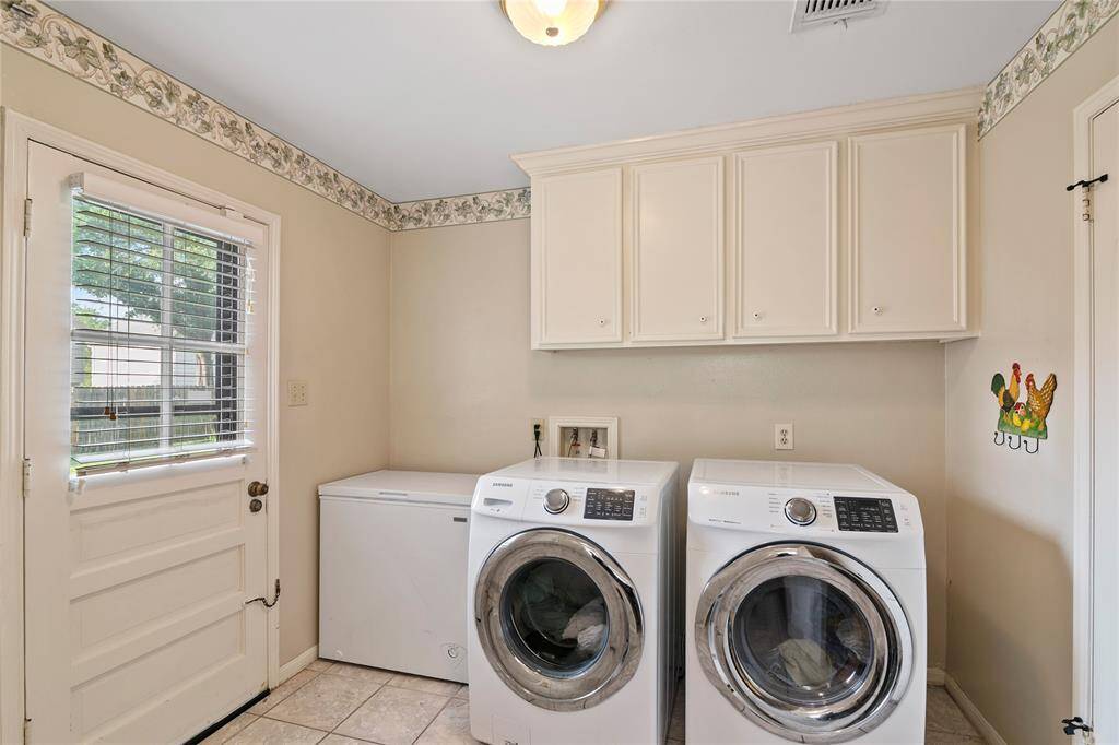 Large Utility Room doubles as mud room - entry from garage and backyard - Freezer space and cabinets.