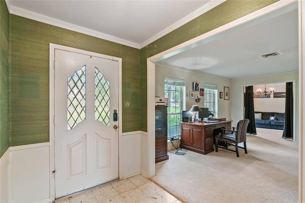 Foyer opens up to the Living room, here used as the study