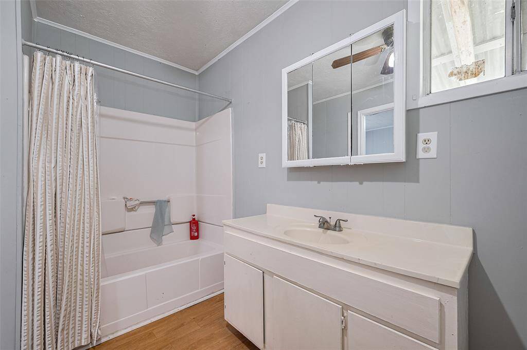 A second full bathroom includes a tub-shower combo and a well-proportioned vanity, completing the main house with thoughtful utility.