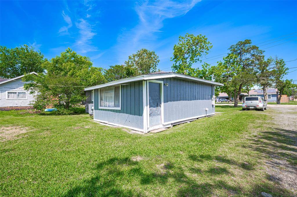 Behind the home, lush grass stretches out—offering a perfect canvas for outdoor gatherings, gardens, or recreational space.