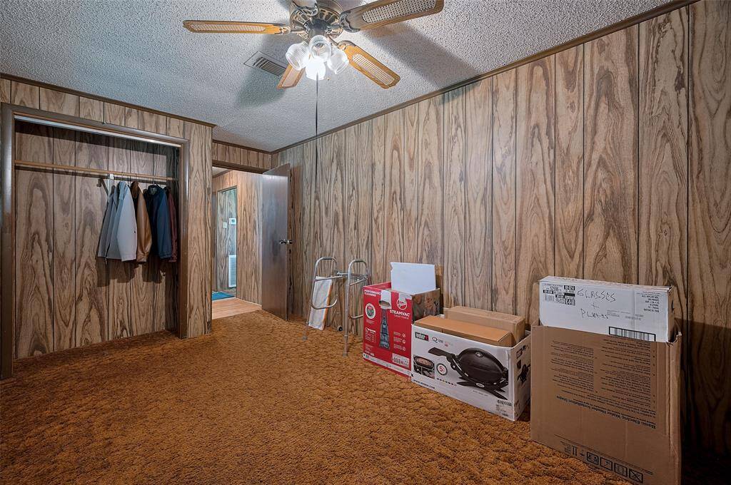 Another bedroom, also carpeted, includes a built-in closet and room to stretch out—well-suited for tenants, guests, or work-from-home needs.