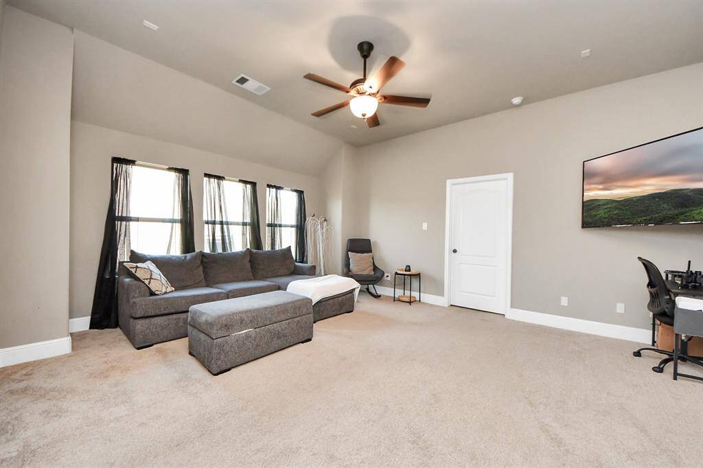Bright, versatile flex space with large windows for natural light on second level.