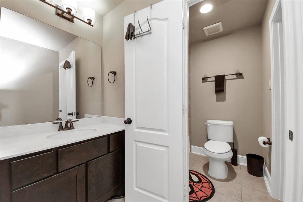 Full bathroom with vanity area separate from shower.