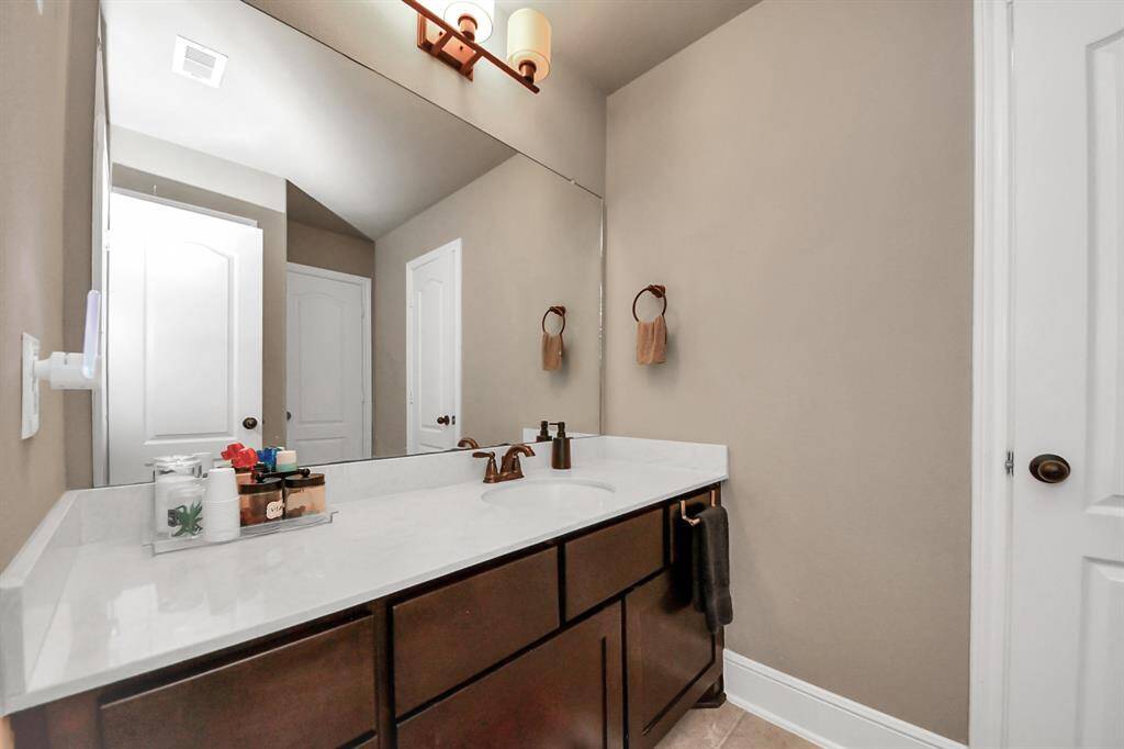 Spacious bathroom with built-in cabinets and plenty of storage.
