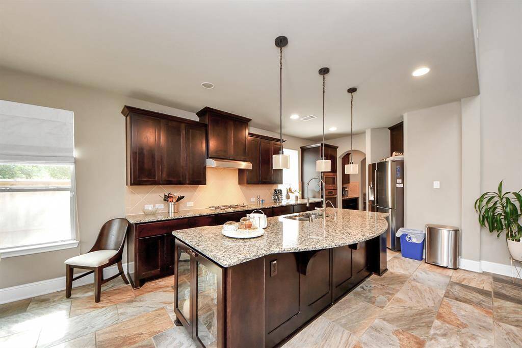 The room is bright with natural light and has a modern, elegant design with tiled flooring.