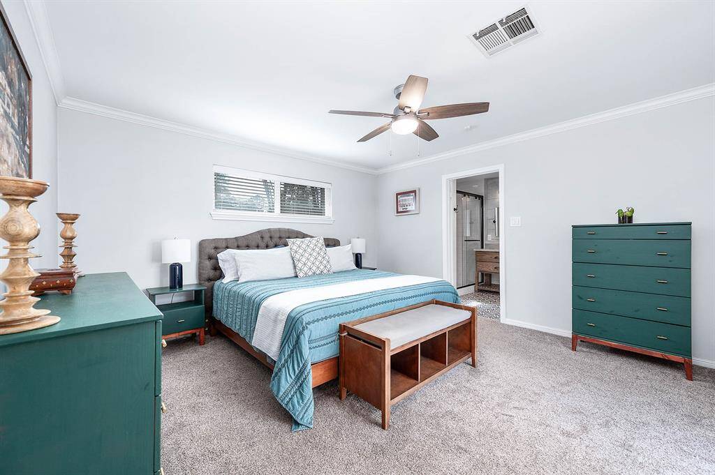 Primary bedroom off the back right of the home is of good size and features an en-suite bath.