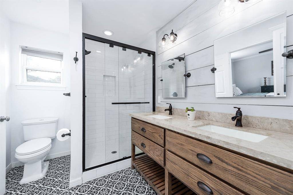 Beautiful, modern primary bathroom featuring dual vanity sinks and walk in shower.