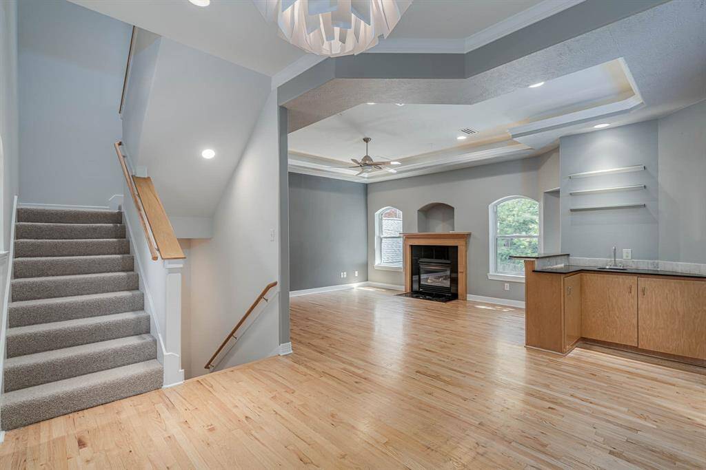 A stylish wet bar and well-appointed butler’s pantry seamlessly connect the dining room and living room, offering both convenience and elegance—ideal for effortless entertaining and everyday functionality