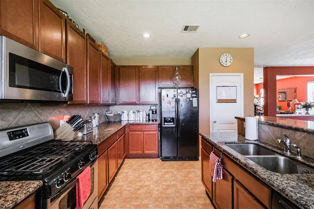 Plenty of Granite Countertops with tiled back splash.