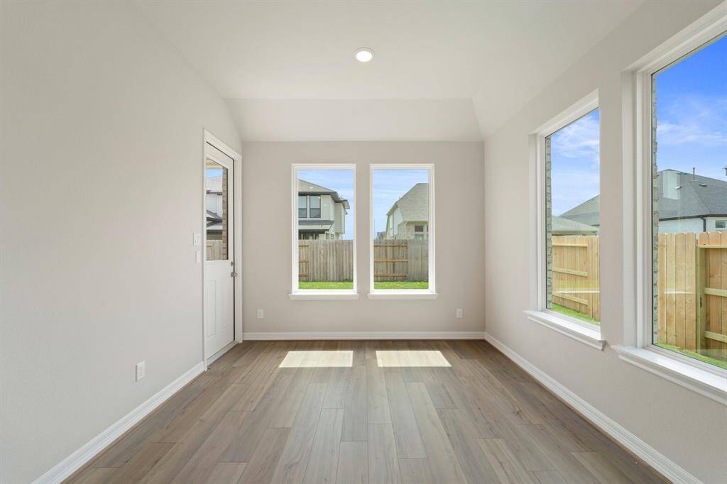 With an abundance of natural light streaming through the windows, the breakfast nook is bathed in a sunny glow, creating the perfect atmosphere to enjoy your morning coffee or a family breakfast.