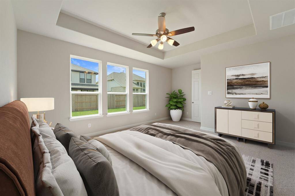 The primary bedroom is generously sized, creating a tranquil and spacious retreat that offers ample room for relaxation. Featuring plush carpet, high ceilings, fresh paint, and large windows that lets in natural lighting throughout the day.