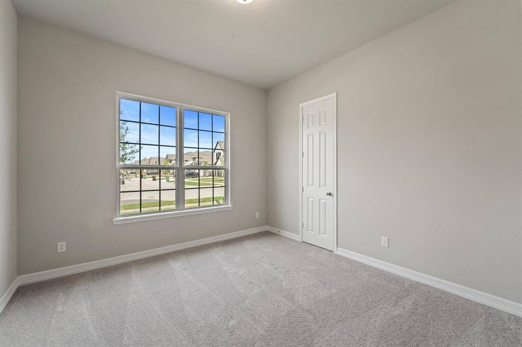 Your secondary bedroom features plush carpet, fresh paint, closet, and a large window that lets in plenty of natural lighting.