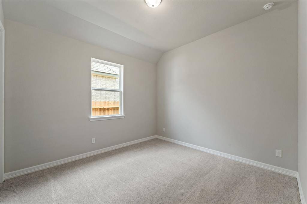 Your secondary bedroom features plush carpet, fresh paint, closet, and a large window that lets in plenty of natural lighting.