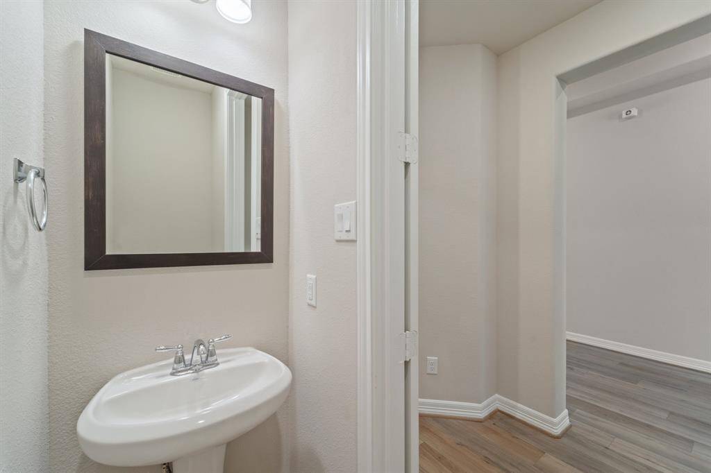 This charming home features a beautifully appointed half bath adjacent to the family room, perfect for welcoming guests and adding convenience to your daily life.