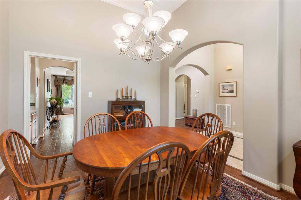 Step into the elegant dining room, where sophistication meets comfort. This spacious area is perfect for hosting dinner parties or enjoying intimate family meals.
