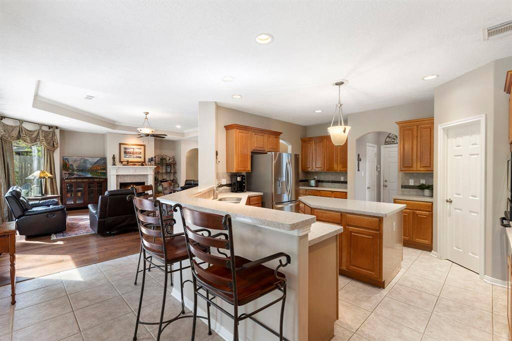 The expansive island provides ample space for meal preparation and entertaining, while the sleek countertops and modern appliances make cooking a delight. Whether you're hosting a dinner party or enjoying a quiet meal at home, this kitchen is designed to inspire your inner chef. The open layout seamlessly connects the kitchen to the living and dining areas, creating a perfect flow for gatherings and everyday living.