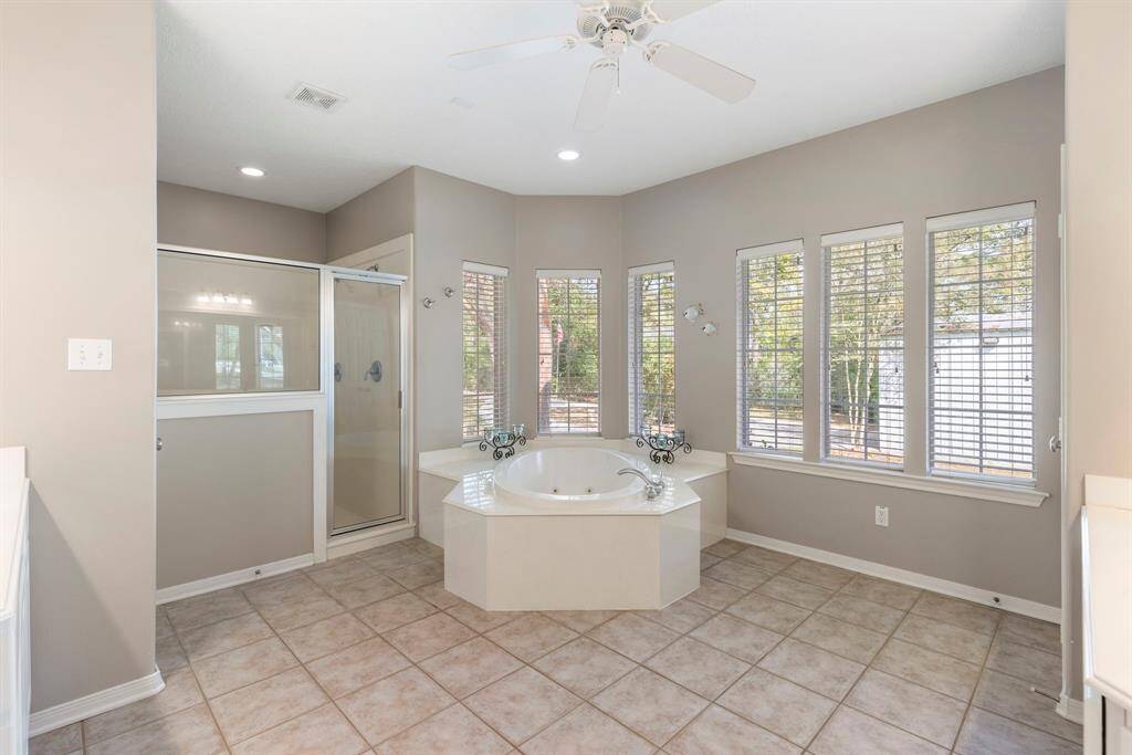 Indulge in the luxurious amenities of the primary bathroom, a true haven of relaxation and style. This exquisite space features a garden jetted tub, perfect for unwinding after a long day, and an oversized separate shower that offers a spa-like experience.