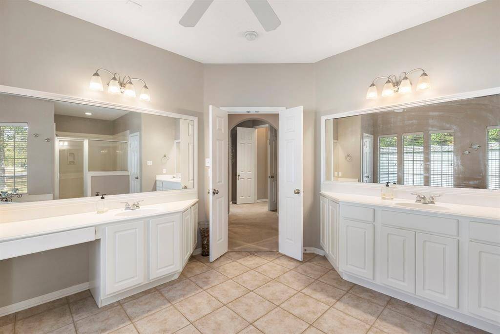 The double sinks with a vanity provide ample space for morning routines, while two walk-in closets offer generous storage and organization. Every detail of this bathroom has been thoughtfully designed to enhance your daily living experience, making it a standout feature of this exceptional home.