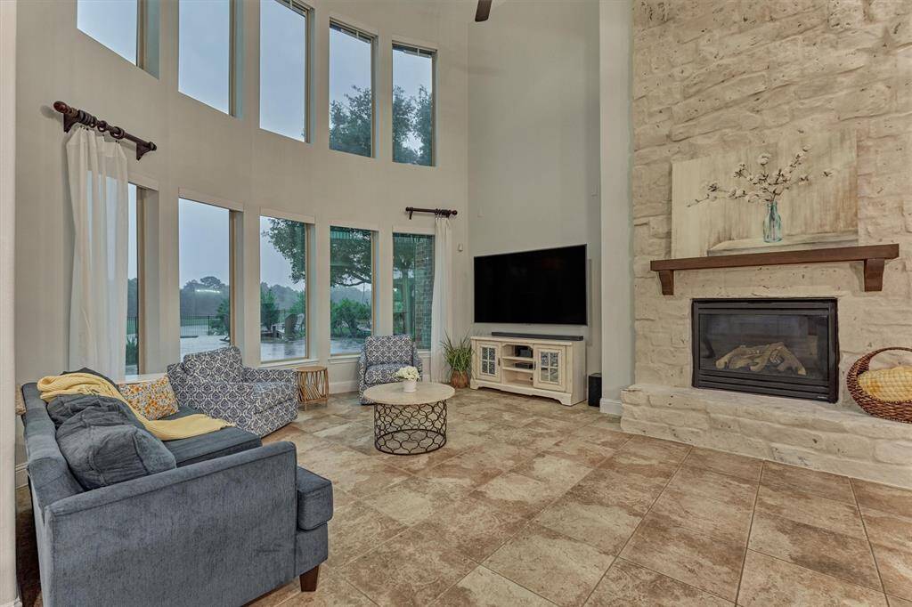 Stunning stone fireplace with German Schmear and light colored walls set the tone in this family room