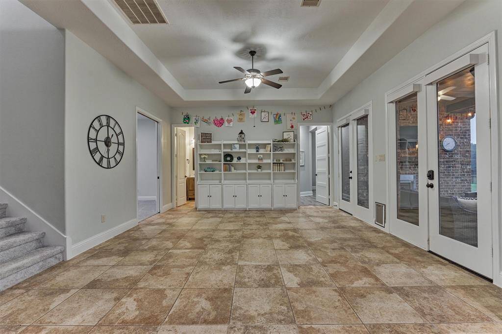 Here is the downstairs game room; there is also  another game room upstairs, the home features dual staircases as well. This is the staircase that takes you upstairs from the kitchen/breakfast area.