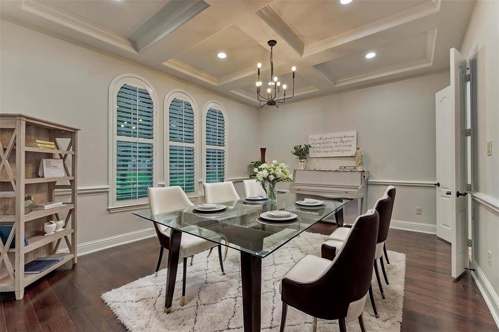 Formal dining room w chandelier, chair rail and hersheys ceiling. *virtually staged*