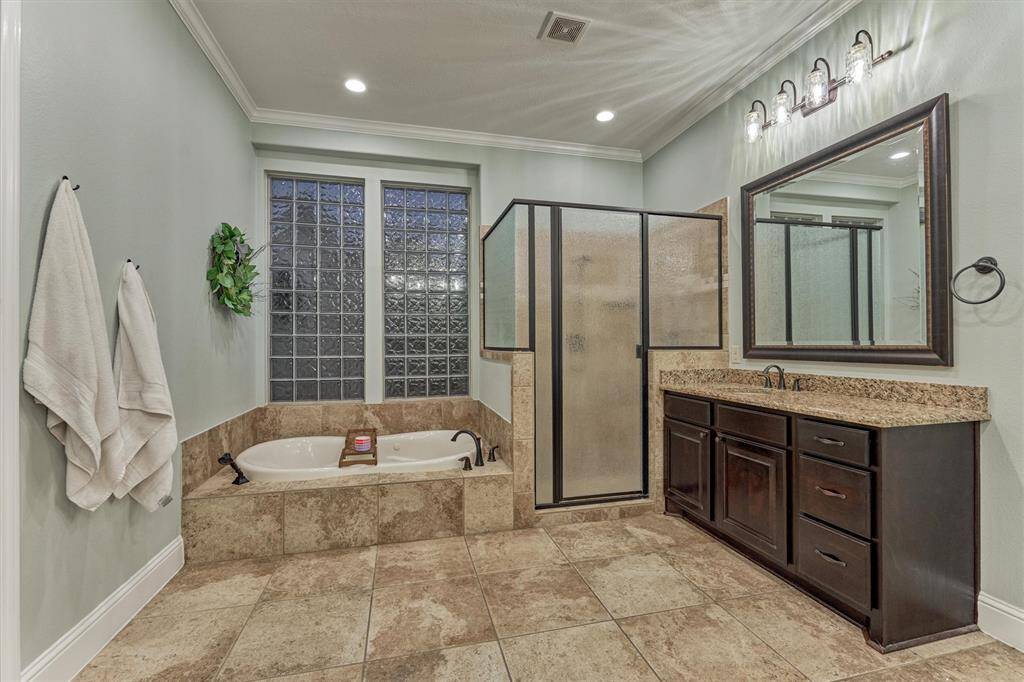 Primary bath offers a jetted tub, large separate shower and his and her sinks as well as his and hers separate closets