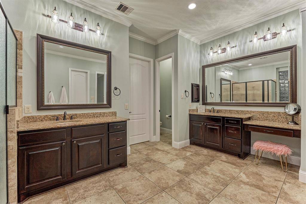 His and hers sinks, framed mirrors and vanity