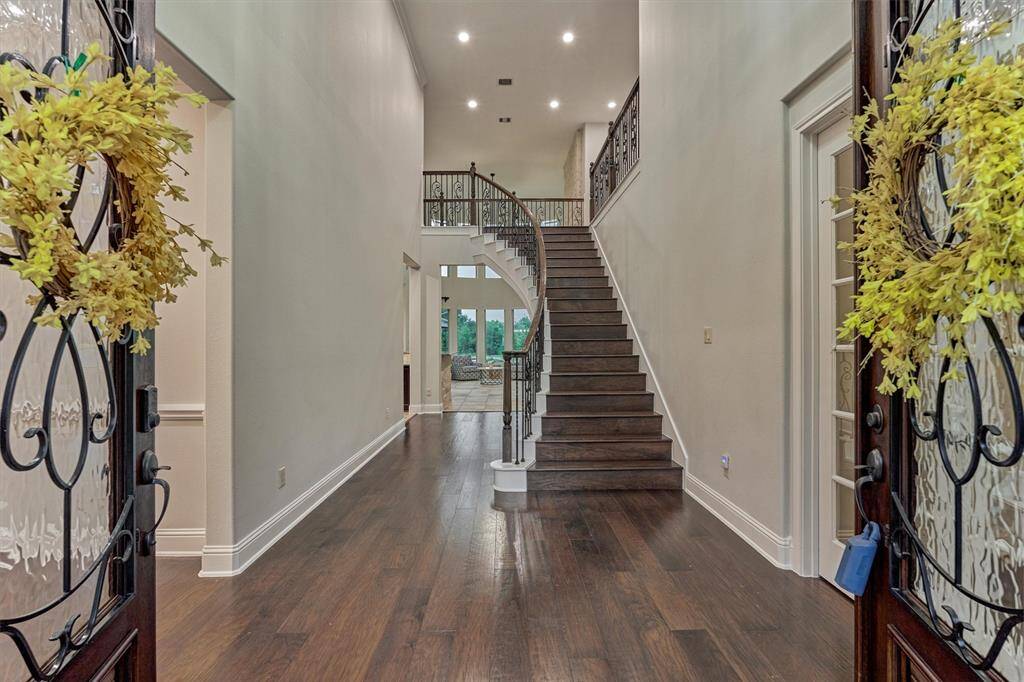 Dual doors greet you as you walk inside where you’ll find gleaming engineered wood floors. Two story entry way and light colored walls set the tone as you enter this haven