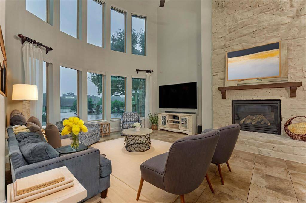 Family room features high ceilings and views to the beautiful backyard and serene backdrop