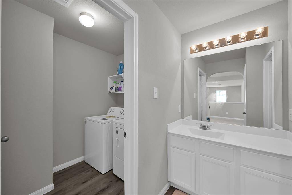 Convenient upstairs laundry room access from bathroom.